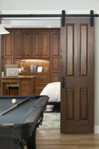 A photo of a pool table and pull-out bed in a lower level